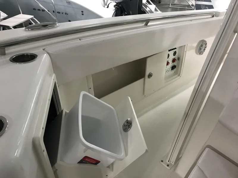 Slide: The Image of 2024 Robalo R302 boat interior with storage compartment and control panel. - 23