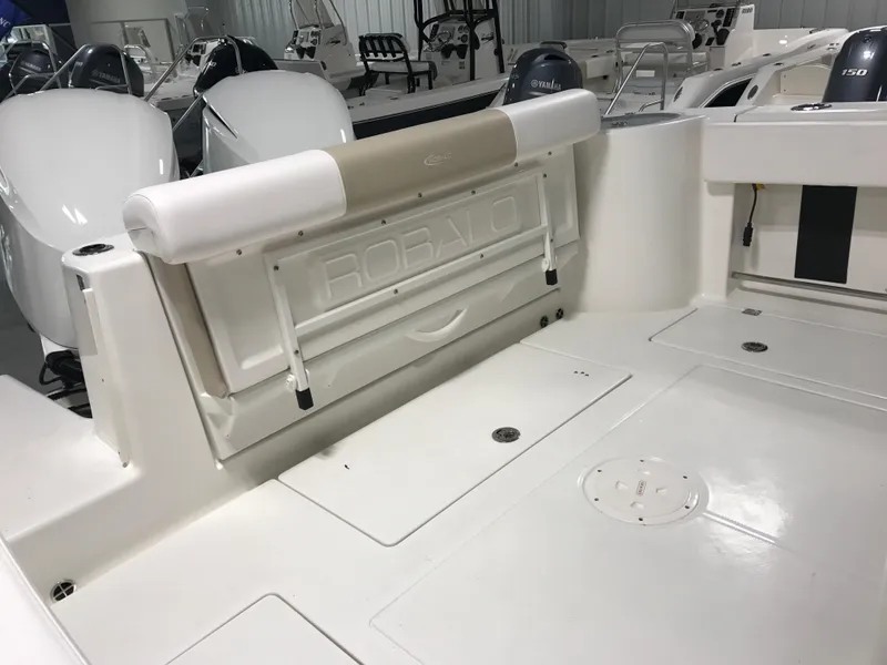 Slide: The Image of 2024 Robalo R302 boat interior with foldable seating and storage compartments. - 5