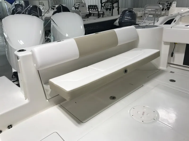 Slide: The Image of 2024 Robalo R302 boat interior with foldable bench seat in white and beige. - 7