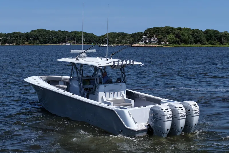 Slide: The Image of 2021 SeaVee 370z boat with triple Mercury 400 engines on a calm lake. - 10