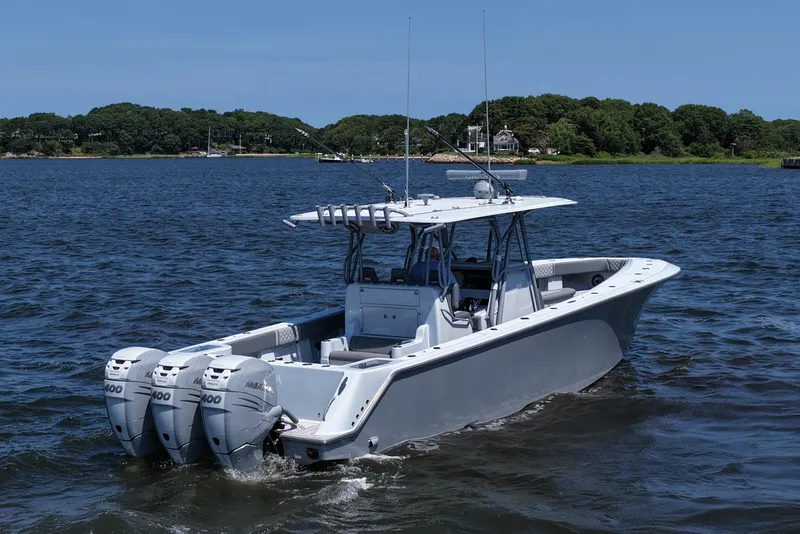 Slide: The Image of 2021 SeaVee 370z boat with triple outboard engines on a calm lake. - 12