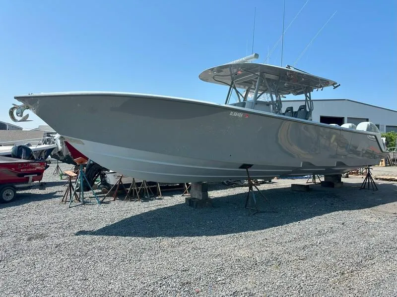 Slide: The Image of 2021 SeaVee 370z boat on stands in a gravel yard, clear sky background. - 17