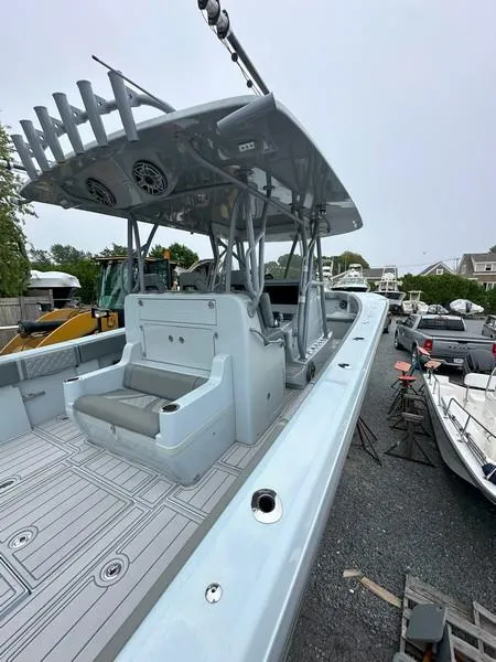 Slide: The Image of 2021 SeaVee 370z boat with spacious deck and seating, parked outdoors. - 21