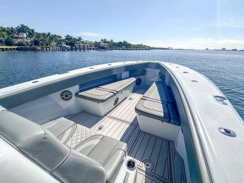 Slide: The Image of 2021 SeaVee 370z boat interior with cushioned seating, on calm water. - 23
