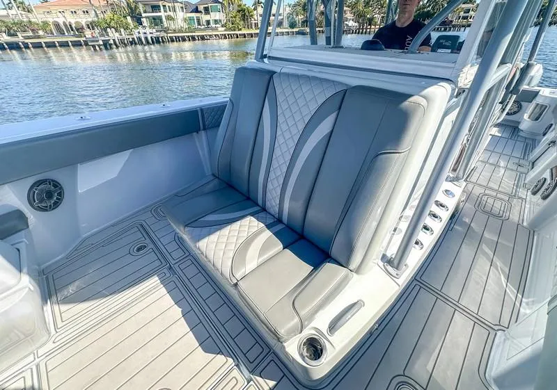 Slide: The Image of 2021 SeaVee 370z boat interior with gray cushioned seating and sleek design. - 24