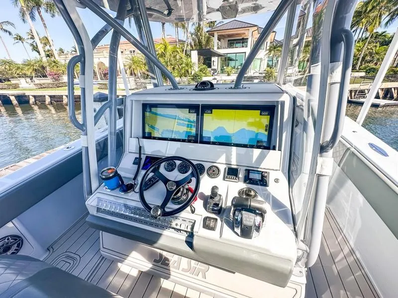 Slide: The Image of 2021 SeaVee 370z boat cockpit with dual navigation screens and modern controls. - 29