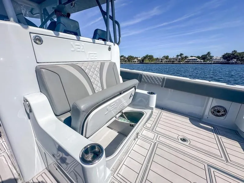 Slide: The Image of 2021 SeaVee 370z boat interior with seating and storage, overlooking a scenic waterfront. - 30