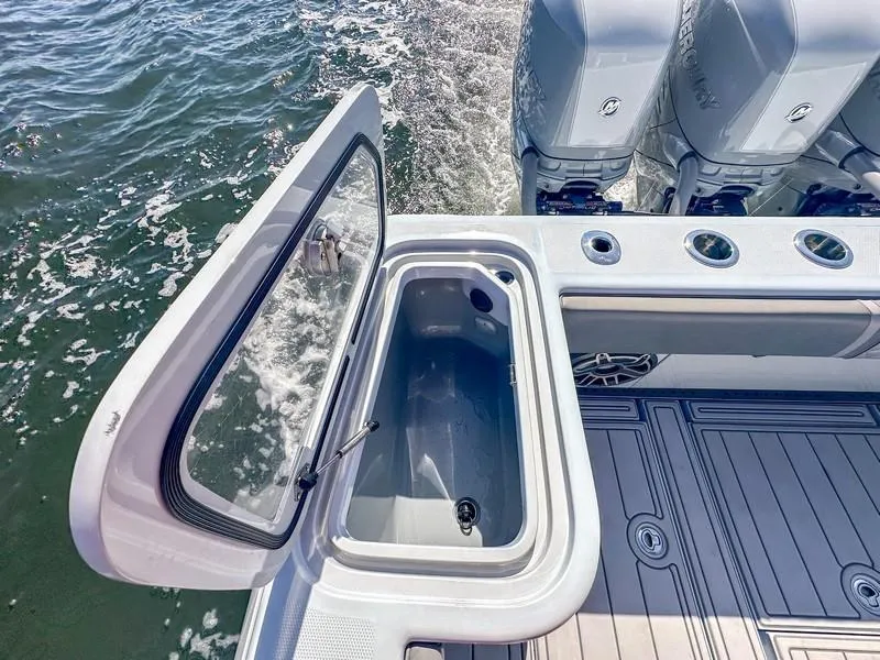 Slide: The Image of 2021 SeaVee 370z boat with open storage compartment and powerful outboard engines. - 31
