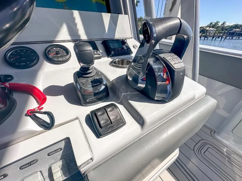 Slide: The Image of Control panel of a 2021 SeaVee 370z boat with throttle and gauges. - 32