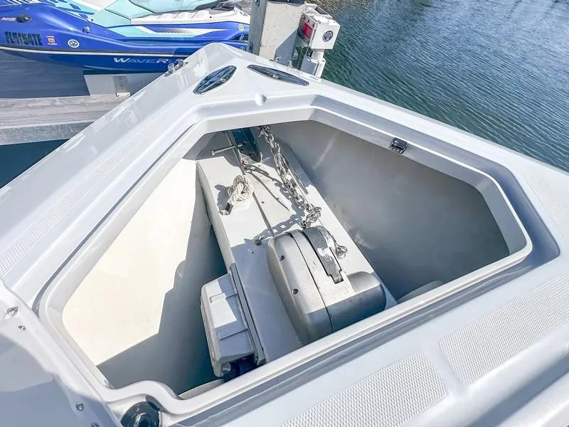 Slide: The Image of Open anchor locker on a 2021 SeaVee 370z boat, showing chain and storage. - 34