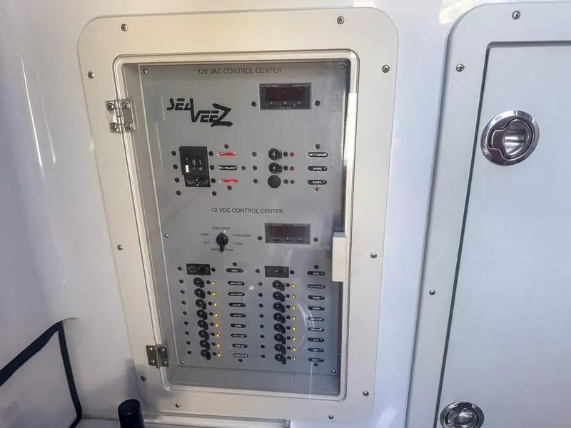 Slide: The Image of Control panel of a 2021 SeaVee 370z boat, featuring 120VAC and 12VDC systems. - 38