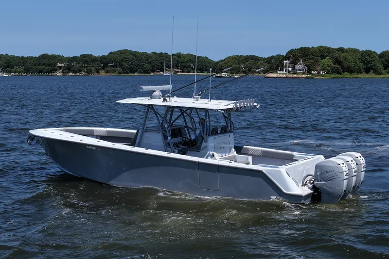 Slide: The Image of 2021 SeaVee 370z boat on water with triple Mercury engines, scenic background. - 9