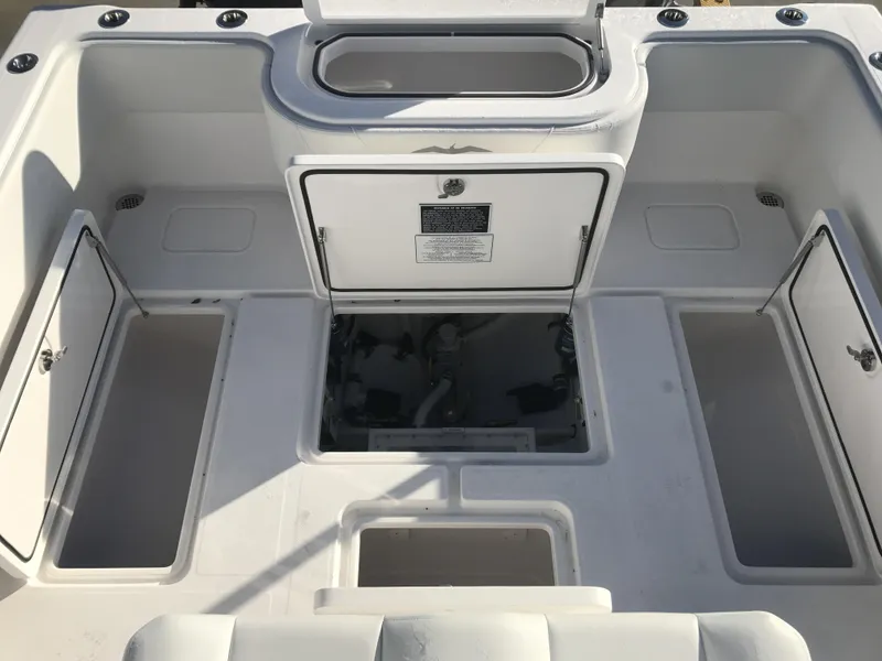 Slide: The Image of 2024 Invincible 36 boat deck with storage compartments and access hatches. - 11