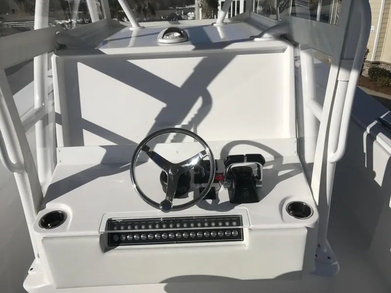 Slide: The Image of 2024 Invincible 36 boat helm with steering wheel and controls. - 6