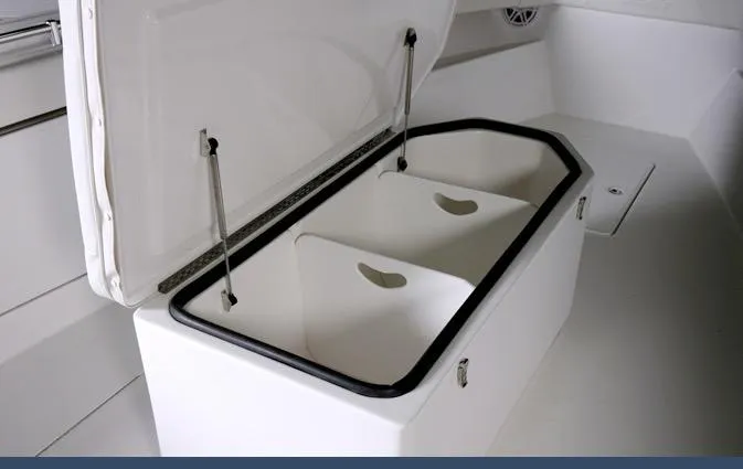 Slide: The Image of 2024 Invincible 42 boat storage compartment with open lid and dual bins. - 7