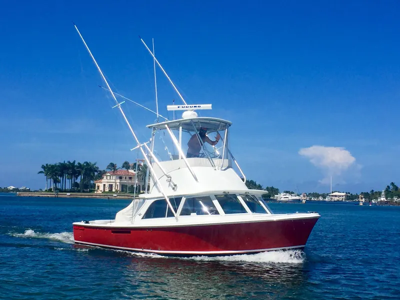 Slide: The Image of 1974 Bertram 31 Sportfisher boat cruising on a sunny day. - 1