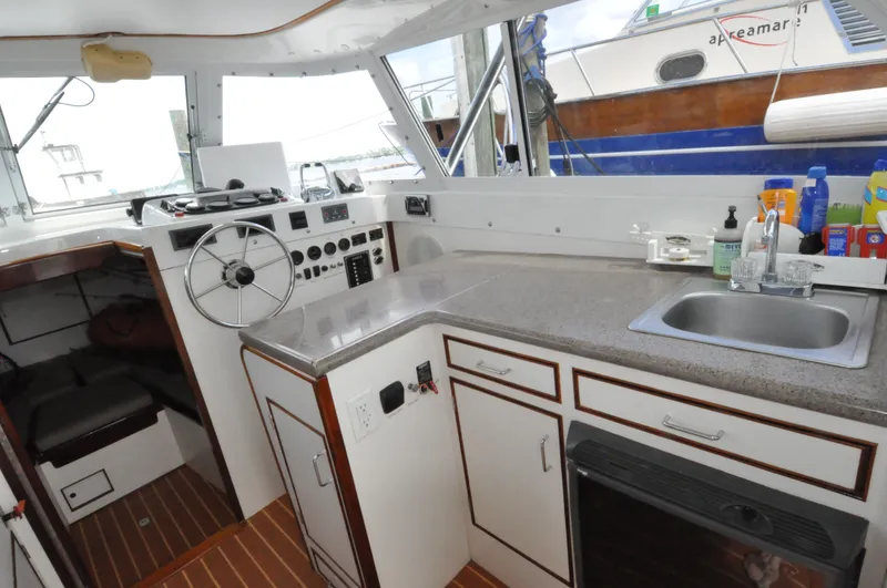 Slide: The Image of 1974 Bertram 31 Sportfisher interior with helm, kitchen sink, and countertop. - 11