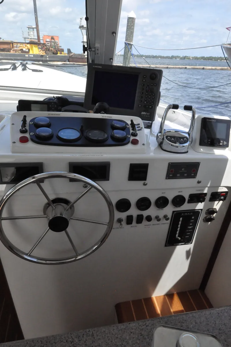 Slide: The Image of Helm of a 1974 Bertram 31 Sportfisher with navigation equipment and steering wheel. - 2