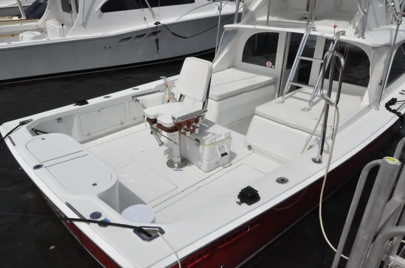 Slide: The Image of 1974 Bertram 31 Sportfisher boat with white deck and fishing chair. - 6