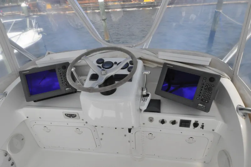 Slide: The Image of 1974 Bertram 31 Sportfisher helm with dual navigation screens and steering wheel. - 8