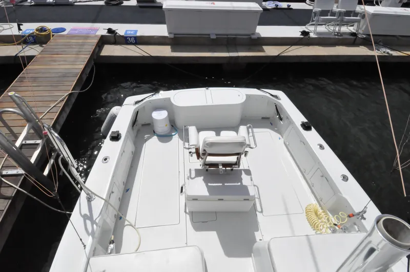 Slide: The Image of 1974 Bertram 31 Sportfisher boat docked at marina, aerial view of deck and seating. - 9