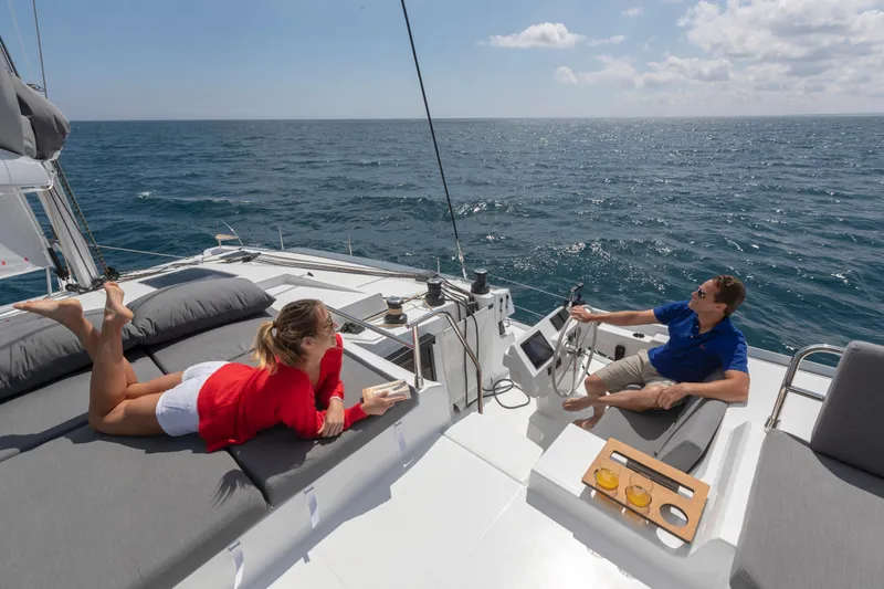 Slide: The Image of Couple relaxing on 2024 Fountaine Pajot Elba 45 catamaran sailing on open sea. - 7