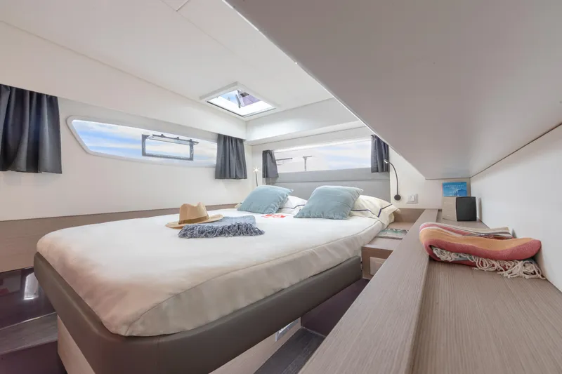 Slide: The Image of Luxurious bedroom interior of 2024 Fountaine Pajot Elba 45 catamaran with skylight and modern decor. - 9