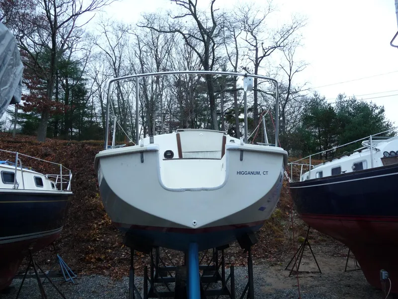 Slide: The Image of 1975 Pearson 26 sailboat on stands in a wooded boatyard. - 3