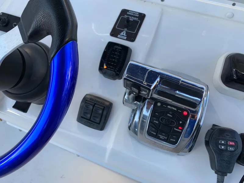 Slide: The Image of Control console of a 2016 Renegade 25 Center Console boat. - 13