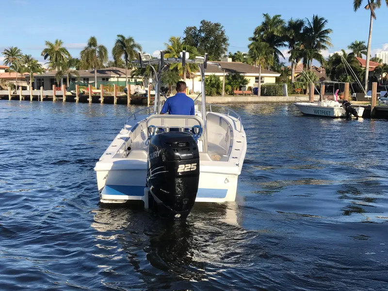 Slide: The Image of 2016 Renegade 25 Center Console on water with outboard motor. - 3
