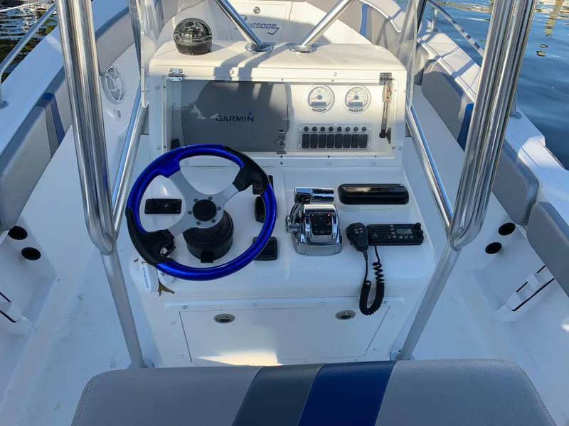 Slide: The Image of 2016 Renegade 25 Center Console with blue steering and Garmin system. - 8