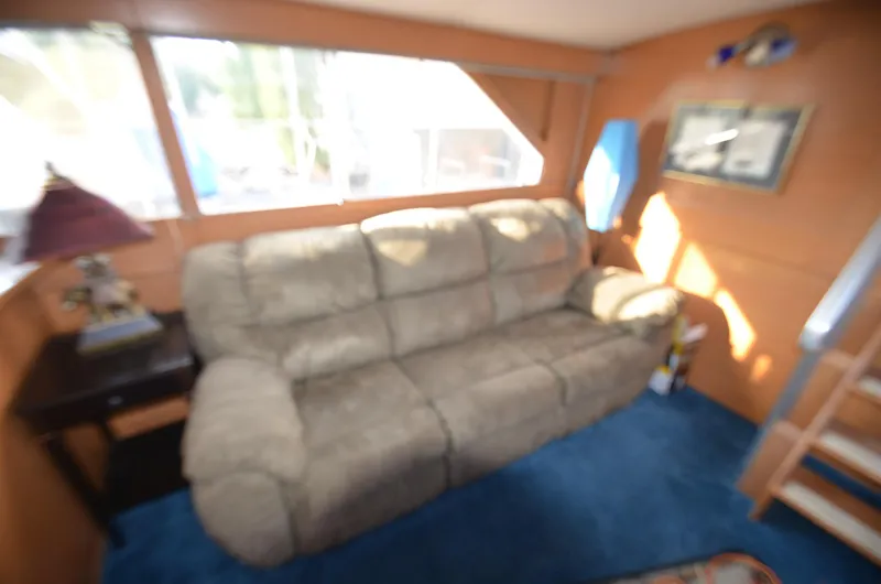 Slide: The Image of Interior of 1964 Chris-Craft Constellation with beige sofa and blue carpet. - 10