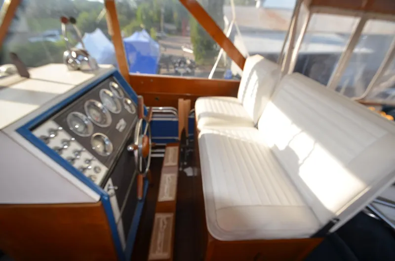 Slide: The Image of 1964 Chris-Craft Constellation boat cockpit with white seats and control panel. - 13