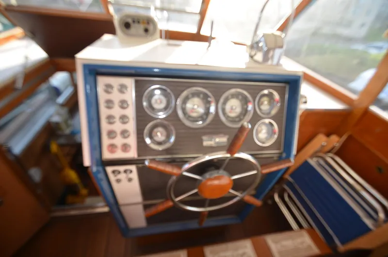 Slide: The Image of 1964 Chris-Craft Constellation boat helm with gauges and steering wheel. - 14