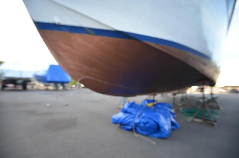 Slide: The Image of 1964 Chris-Craft Constellation boat hull on dry dock with blue tarp. - 2