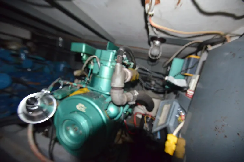 Slide: The Image of 1964 Chris-Craft Constellation engine room with green engine and wiring. - 22