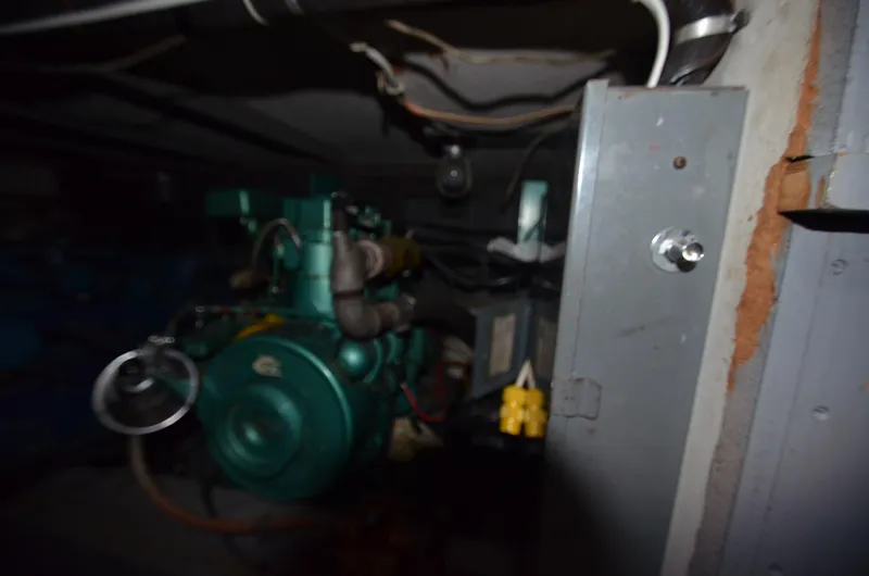 Slide: The Image of 1964 Chris-Craft Constellation engine compartment with visible wiring and machinery. - 23