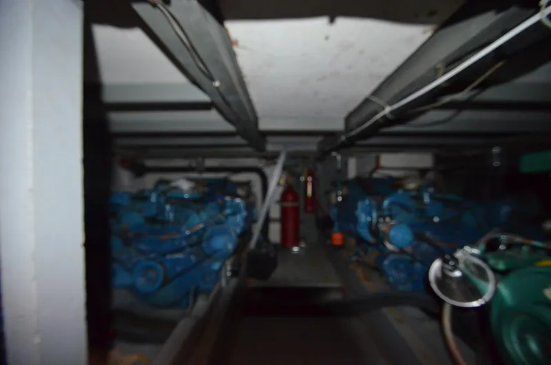 Slide: The Image of Engine room of a 1964 Chris-Craft Constellation boat with twin blue engines. - 24