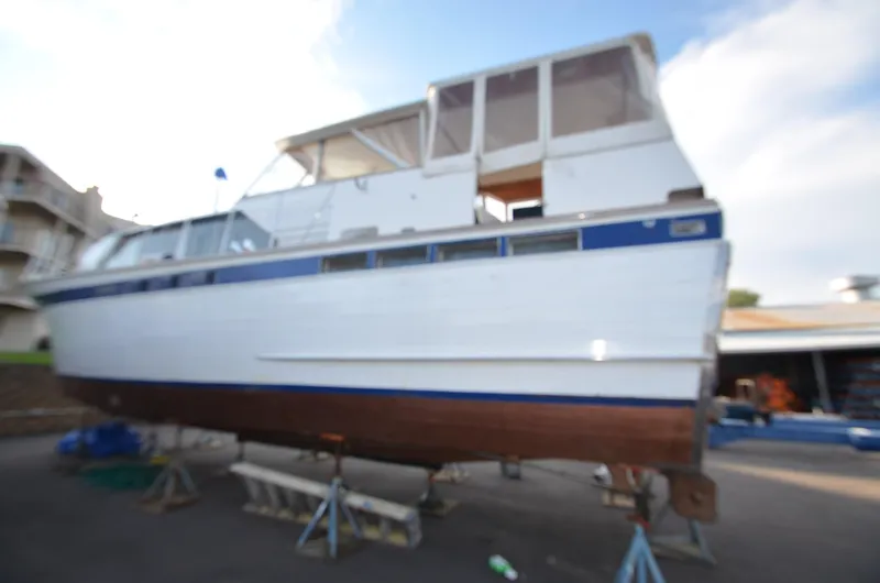 Slide: The Image of 1964 Chris-Craft Constellation boat on stands for maintenance. - 6