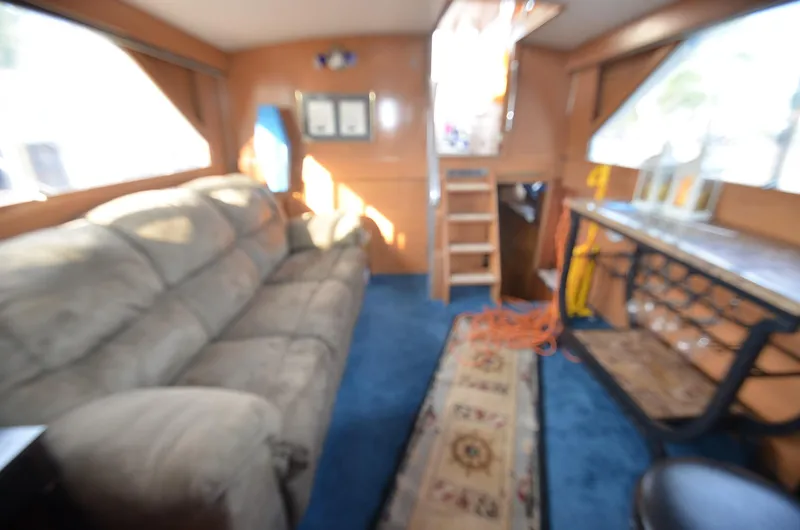 Slide: The Image of Interior of a 1964 Chris-Craft Constellation boat with cozy seating and wooden accents. - 9
