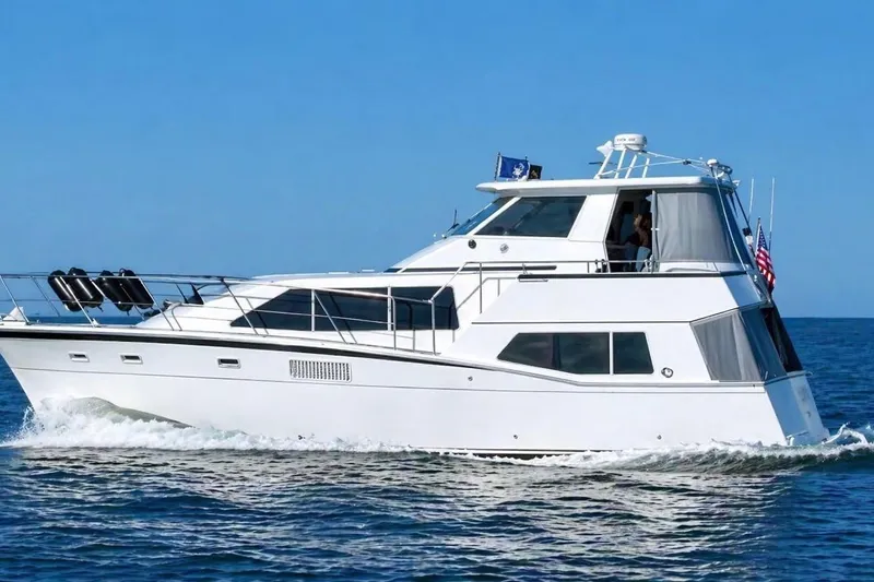 The Image of 1988 Kadey-Krogen Silhouette yacht cruising on open water under clear blue skies. - 0