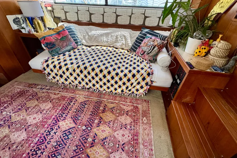 Slide: The Image of Polished wooden table on 1988 Kadey-Krogen Silhouette yacht with cushioned seating. - 16