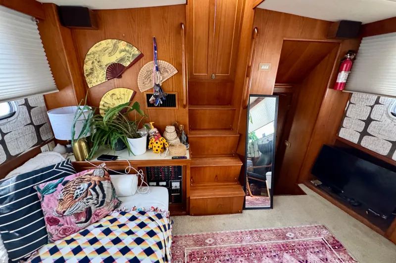 Slide: The Image of Cozy 1988 Kadey-Krogen Silhouette interior with wooden accents, patterned rug, and comfortable seating. - 19