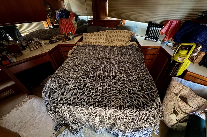 Slide: The Image of Cozy 1988 Kadey-Krogen Silhouette interior with wooden stairs, plants, and decorative elements. - 20