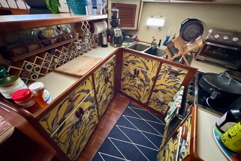 Slide: The Image of Cozy 1988 Kadey-Krogen Silhouette yacht kitchen with floral cabinets and modern appliances. - 27