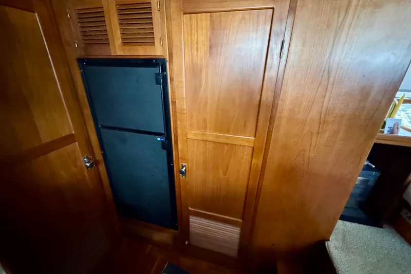 Slide: The Image of 1988 Kadey-Krogen Silhouette yacht kitchen with spice rack, patterned cabinets, and modern appliances. - 28