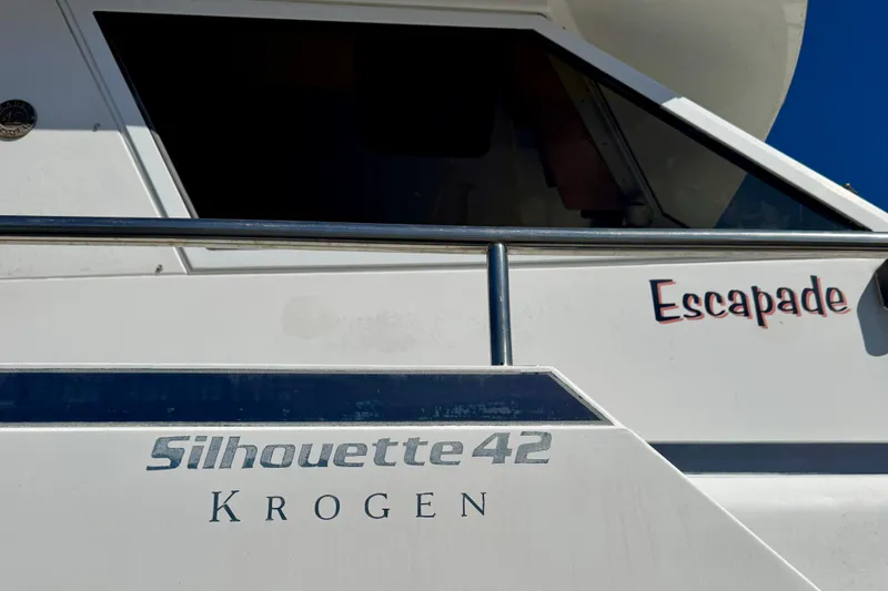 Slide: The Image of Kadey-Krogen Silhouette 1988 boat deck with wooden flooring, overlooking calm water. - 3