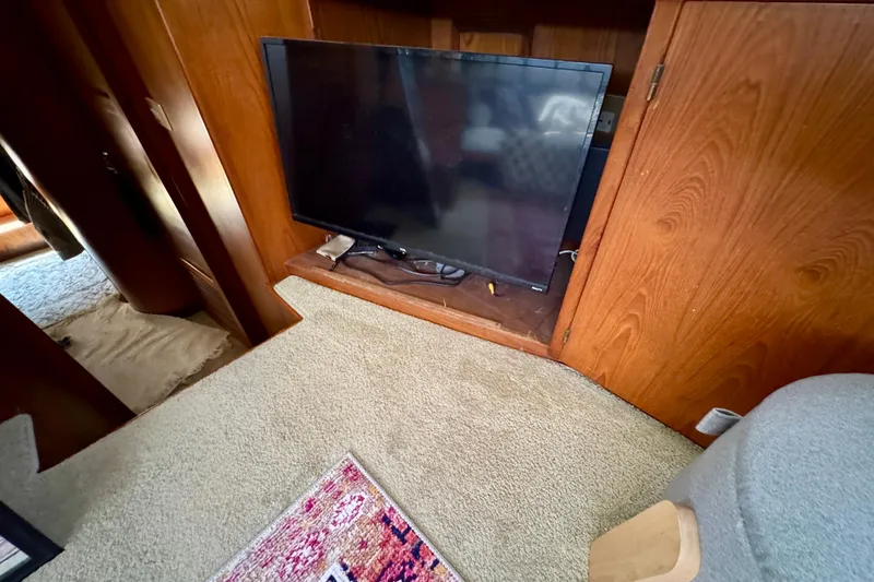 Slide: The Image of Electrical panel on 1988 Kadey-Krogen Silhouette boat with labeled switches and wooden frame. - 37