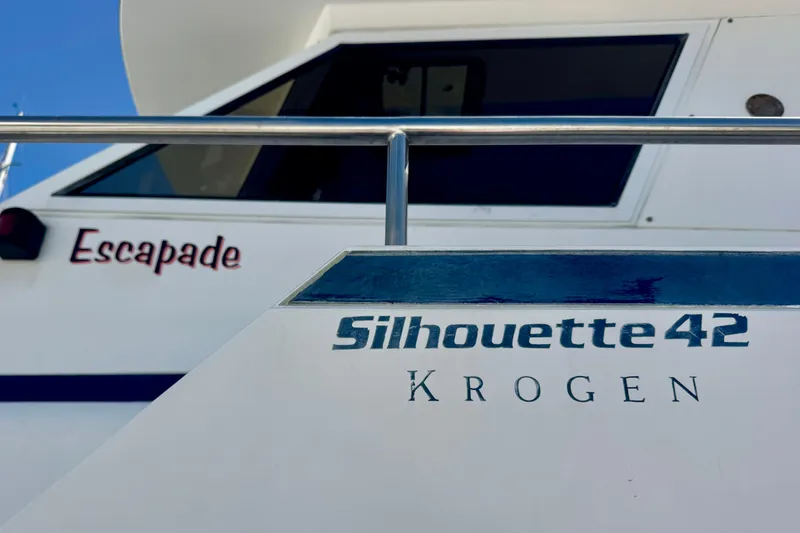 Slide: The Image of Interior of 1988 Kadey-Krogen Silhouette with TV, wooden cabinetry, and carpeted floor. - 38