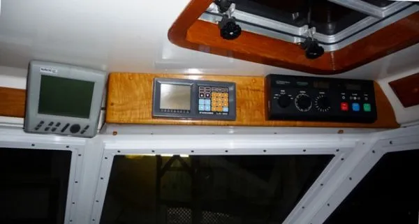 Slide: The Image of Control panel of a 1988 Kadey-Krogen Silhouette boat with steering wheel and throttle levers. - 7